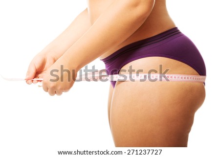 Fat woman measuting her bum.