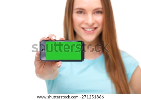 Young beautiful woman holding smartphone with copyspace - isolated on white background.