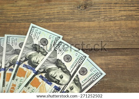 Usa New One Hundred Dollar Bills On The Rustic Rough Wood Table Textured Background