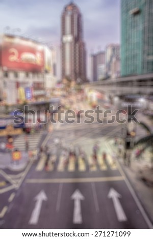 Busy people on street at night in defocused blur concept vintage color style.