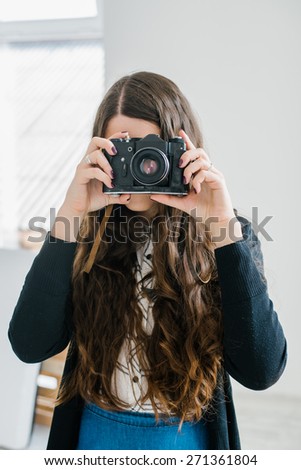 long-haired brunette girl photographed on an old camera