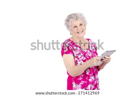 Old woman using a digital tablet against a white background