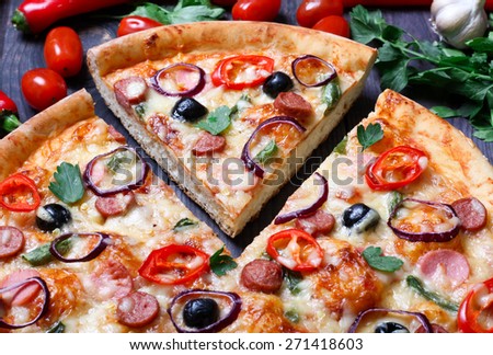 pizza with sausage, olives and chili pepper
