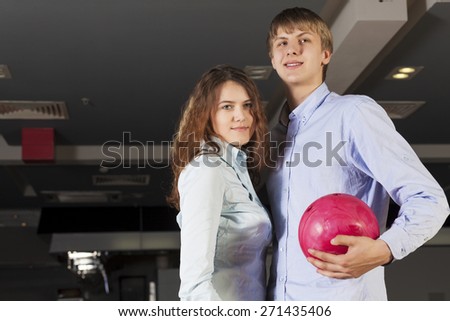 Young couple in bowling club having fun together