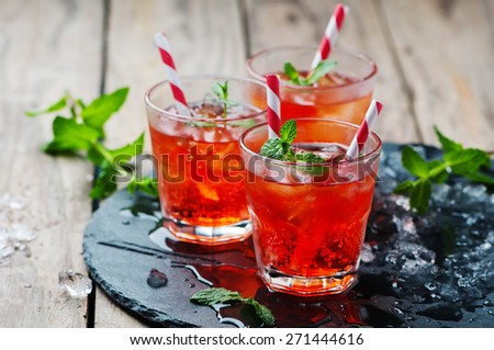 Red Cocktail with mint and ice, selective focus Royalty-Free Stock Photo #271444616