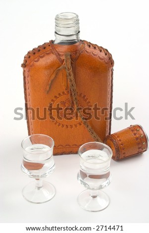 Hipflask and two glasses, isolated on white