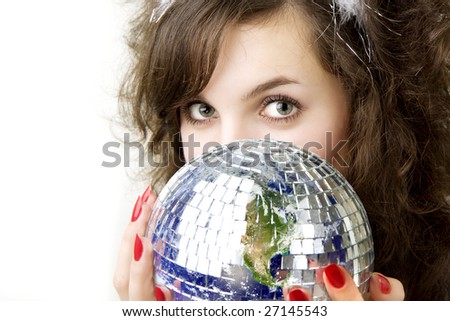 Picture of a beautiful girl, who keeps the ball in the form of the planet Earth in the hands of