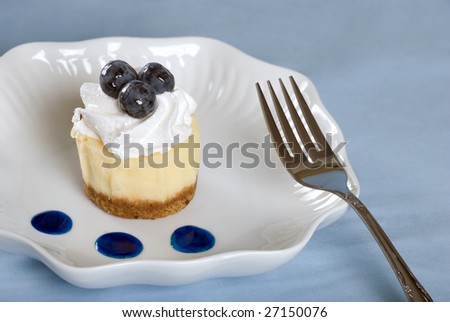 Cheesecake with fresh blueberries and a fork