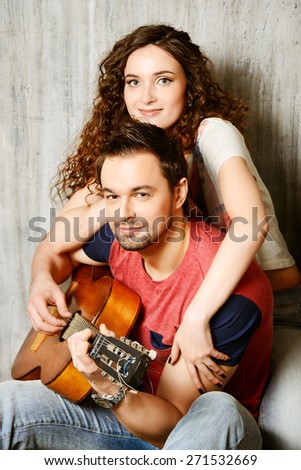 Romantic young man playing the guitar to his beloved girl. Happiness. Love concept.