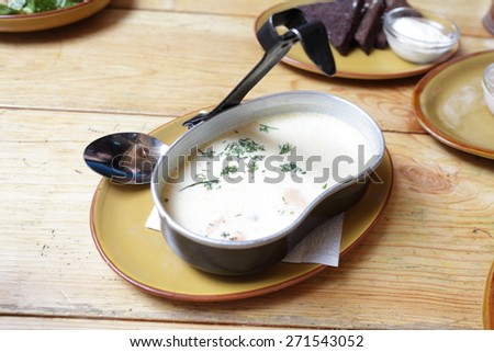 Plate of creamy soup with shrimp, salmon and potatoes