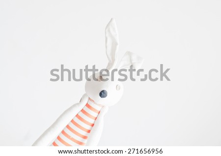 White rag rabbit toy with button eyes