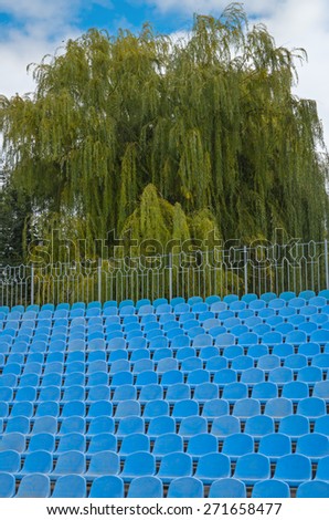 The photographic image of plastic folding chairs on sports arena.