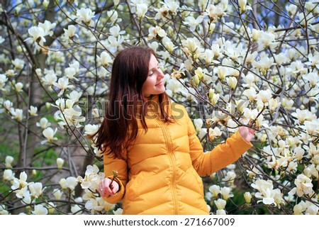 young woman and white magnolias blooming