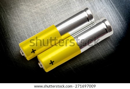 Two batteries with plus sign visible in closeup