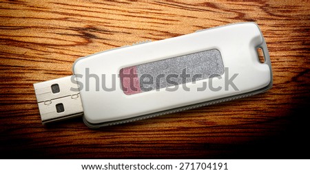 Usb flash drive on the wooden background