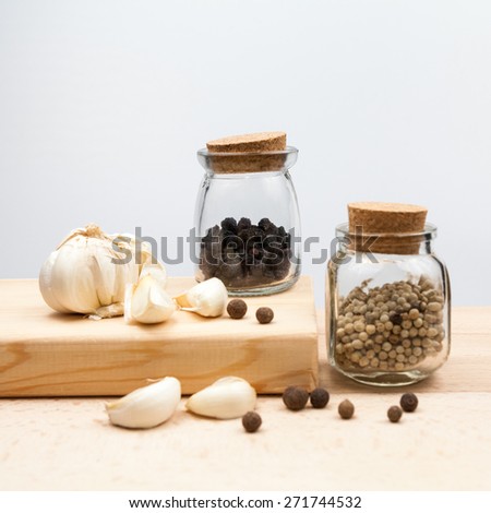 Garlic and spices on wooden kitchen board