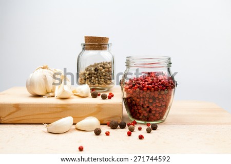 Garlic and spices on wooden kitchen board
