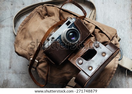 Old camera in bag, vintage photo grunge lighting version design component