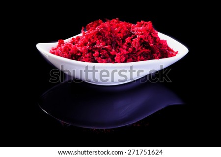 Horseradish sauce (with beet) - A traditional Jewish Passover dish. In a white plate on black background