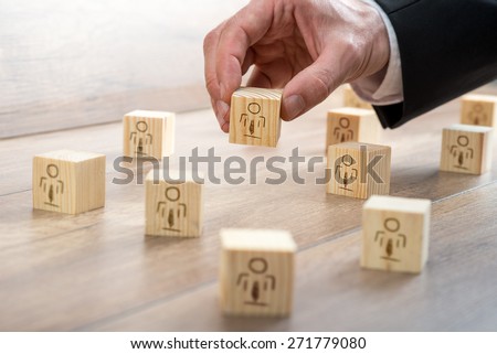 Customer-Managed Relationship Concept - Businessman Arranging Small Wooden Blocks with Symbols on the Table.