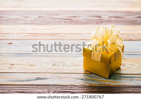 Gift box on wood background - vintage effect style pictures