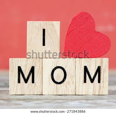 I love Mom. Red heart and Wooden letters spelling I love mom