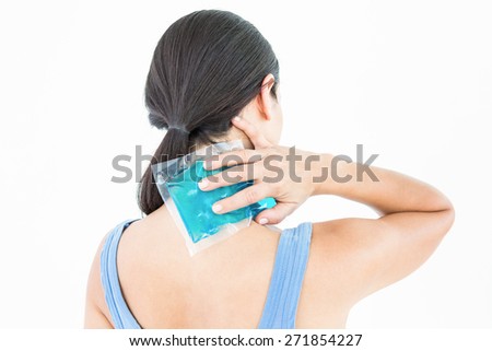 Beautiful brunette putting gel pack on neck on white background Royalty-Free Stock Photo #271854227