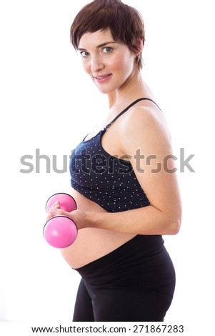 Pregnant woman keeping in shape on white background