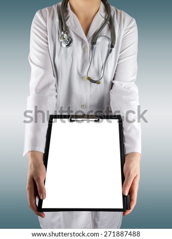 Female doctor's hand holding blank medical clipboard and stethoscope on blurred background. Concept of Healthcare And Medicine. Copy space