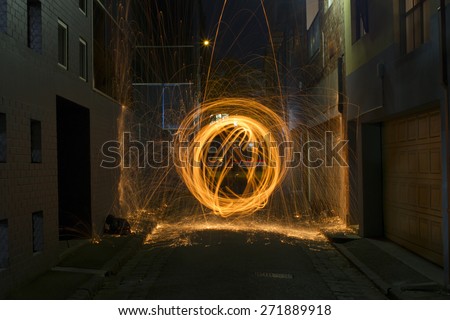 Sparks Flying off Burning Steel Wool in Alleyway