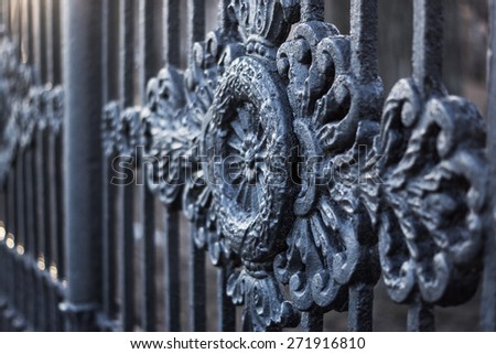 Casting ornament on a wrought cast iron fence in a park