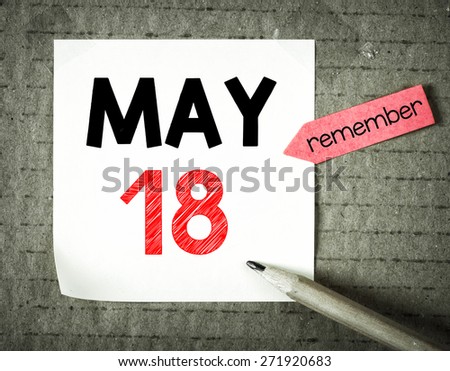 Note with 18 may and pencil on grunge background