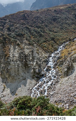 Fall cascade in the foothills of the Himalayas near Thame village - Everest region, Nepal