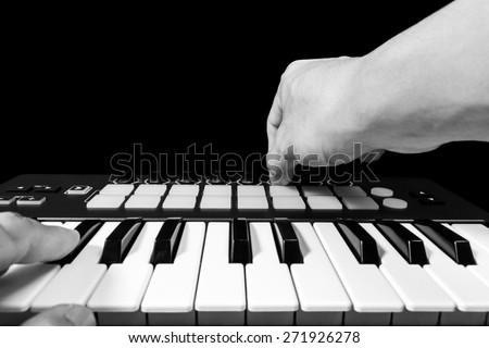 professional musician hands playing studio keyboard synthesizer, bw filter & isolated on black for dance, groove, remix, dubstep background