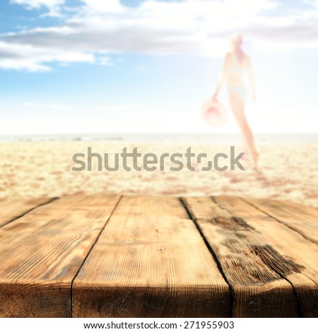 woman in bikini on hot summer sand of beach and big table place and tropical beach 