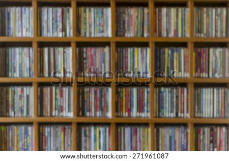 shelf with cd, dvd collection blurry