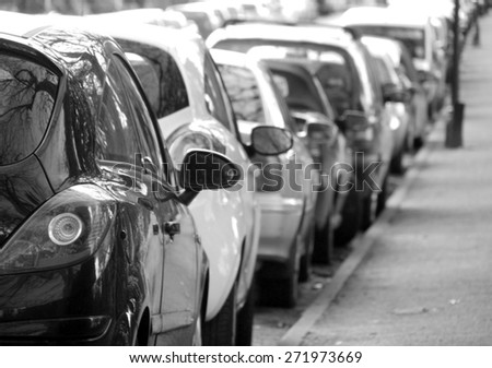 Black and white photograph of cars parked in city centre