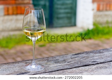 Horizontal Image of a wine glass with 2014 Sauvignon in it.Sharp focus on wine glass with blurred background and copy space on right