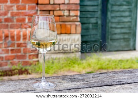 Horizontal Image of a wine glass with 2014 Riesling in it.Sharp focus on wine glass with blurred background and copy space on right