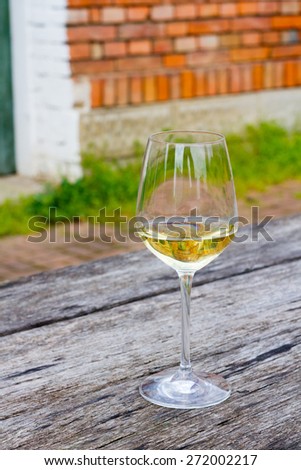 Vertical Image of a wine glass with 2014 Riesling in it.Sharp focus on wine glass 