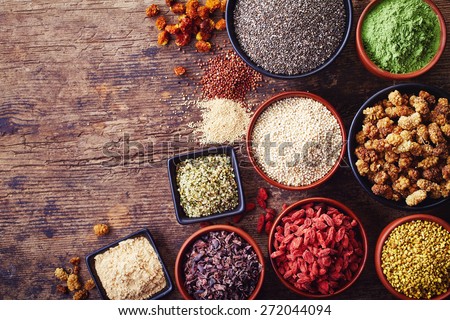 Bowls of various superfoods on wooden  background Royalty-Free Stock Photo #272044094