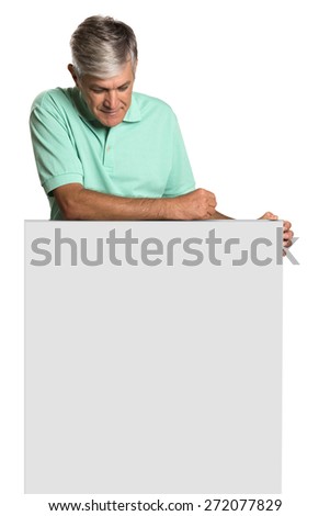 Smiling Young Male Engineer in Orange Head Protector Holding card. Standing on White Background