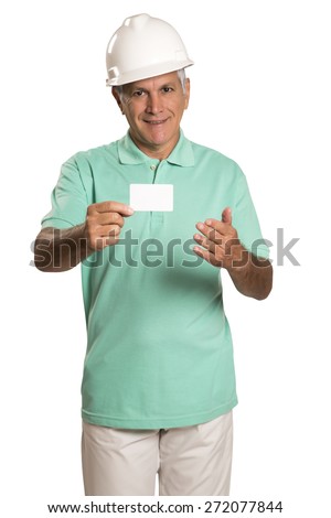 Smiling Young Male Engineer in Orange Head Protector Holding card. Standing on White Background