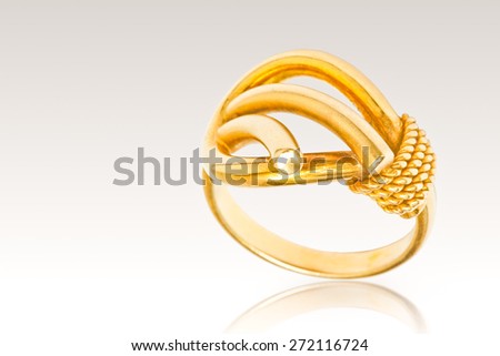 Golden rings isolated on gray
