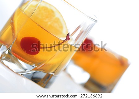 Glass of orange juice with cherry