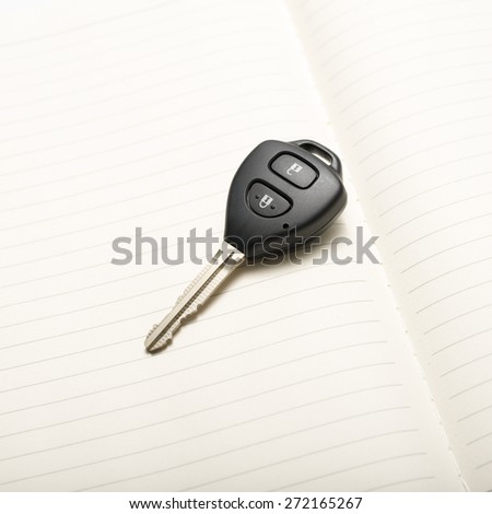 car key on notebook paper