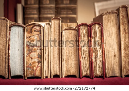 Books with leather covers in a row. Old manuscripts. Aged, used books. Royalty-Free Stock Photo #272192774