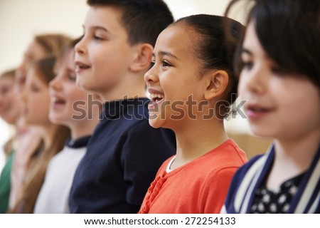 Group Of School Children Singing In Choir Together Royalty-Free Stock Photo #272254133