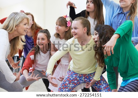 Group Of Children With Teacher Enjoying Drama Class Together Royalty-Free Stock Photo #272254151