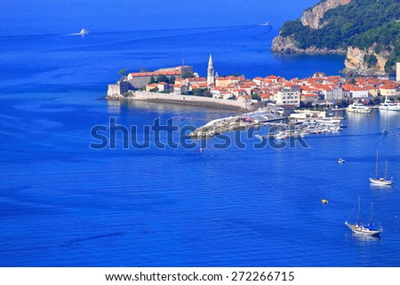 Small boats on the Adriatic sea near old harbor and town, Budva, Montenegro